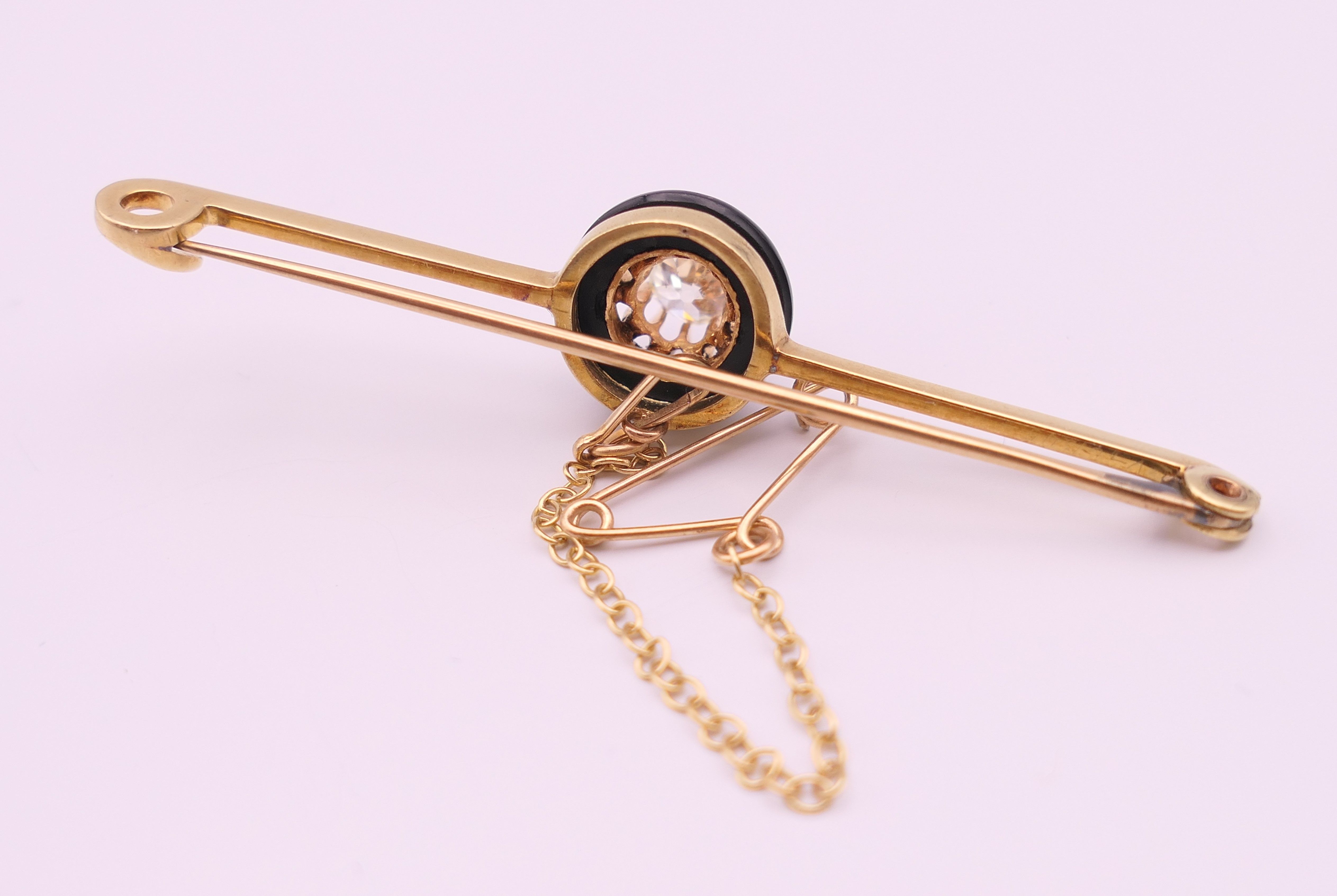 A 15 ct gold and 0.5 carat diamond set in a black circular mount mourning brooch/pin. 6 cm long. 4. - Image 2 of 5
