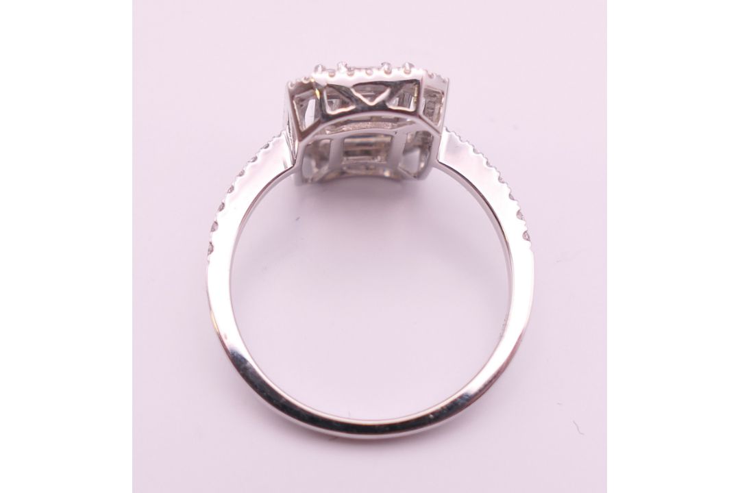 An 18 ct white gold ring with 5 baguette cut diamonds surrounded by numerous brilliant cut diamonds. - Image 6 of 8