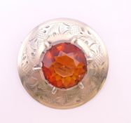 A 19th century circular silver plaid brooch/cloak pin engraved with thistles,