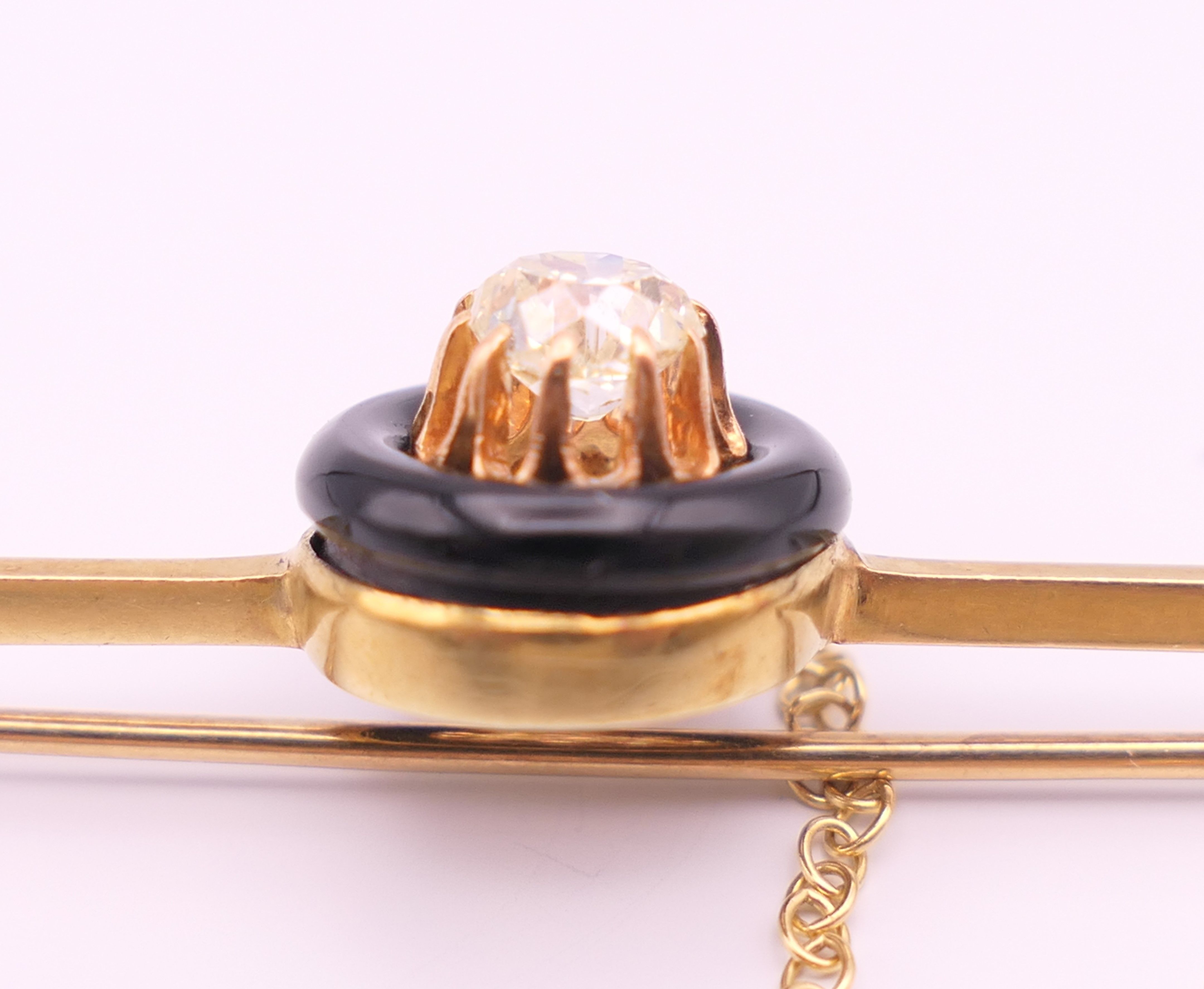 A 15 ct gold and 0.5 carat diamond set in a black circular mount mourning brooch/pin. 6 cm long. 4. - Image 3 of 5