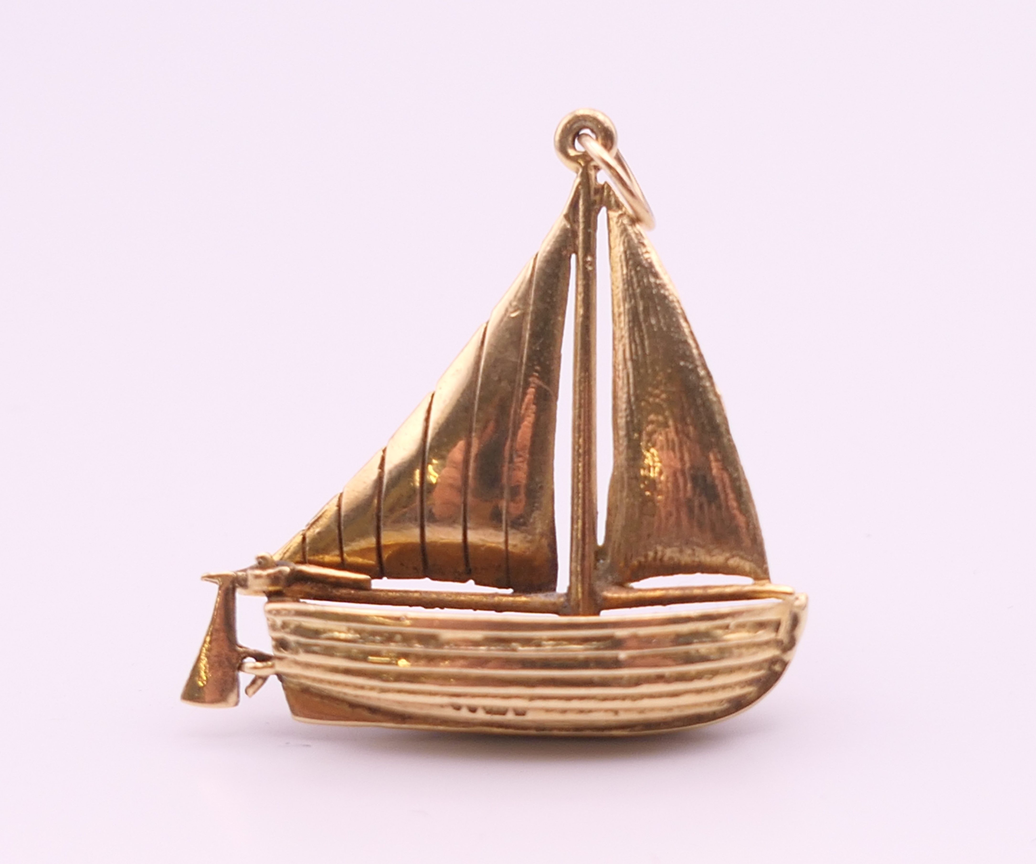 A 9 ct gold pendant formed as a sailing boat. 3 cm x 3.25 cm high. 6.9 grammes.