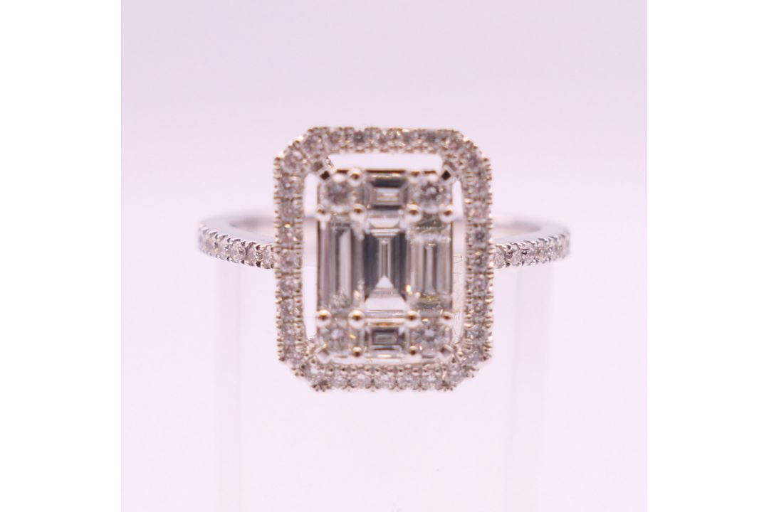 An 18 ct white gold ring with 5 baguette cut diamonds surrounded by numerous brilliant cut diamonds. - Image 1 of 8