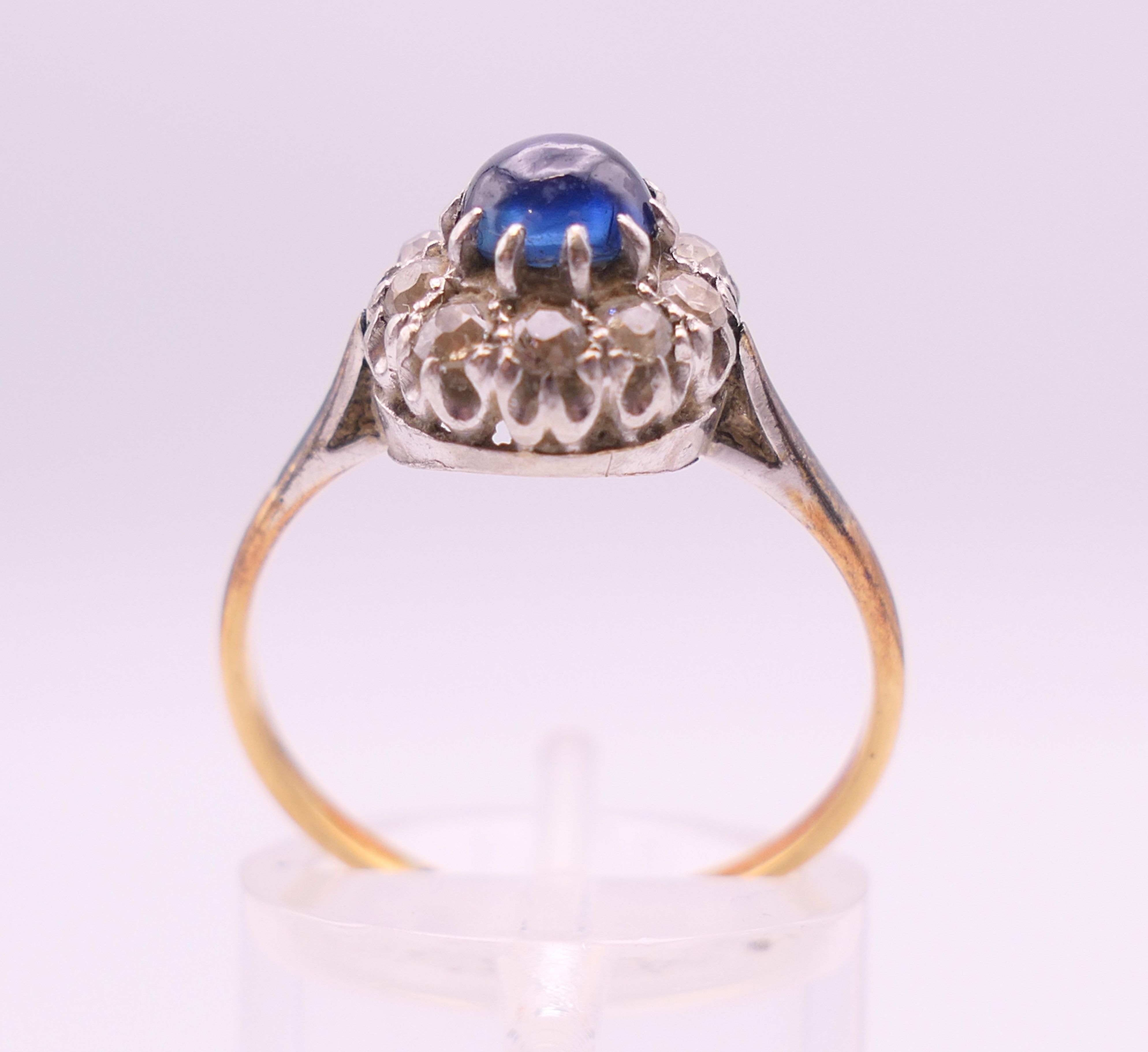 An 18 ct gold and platinum cabochon sapphire and diamond cluster ring. Ring size Q. - Image 4 of 7