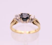 An 18 ct gold diamond and sapphire ring. Ring size N/O. 3.5 grammes total weight.