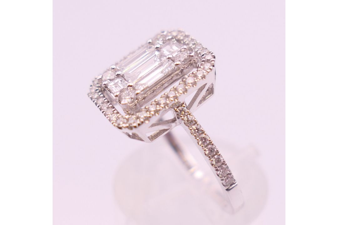 An 18 ct white gold ring with 5 baguette cut diamonds surrounded by numerous brilliant cut diamonds. - Image 5 of 8