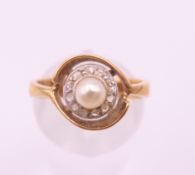 A 14 ct gold diamond and pearl ring. Ring size M.