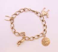 A 9 ct gold charm bracelet. 21 cm long. 25.7 grammes.