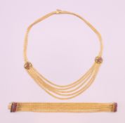An 18 ct gold ruby set necklace, together with an 18 ct gold ruby and sapphire set bracelet.