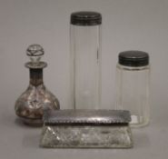 An unmarked silver overlay scent bottle and three silver topped jars. The former 9 cm high.
