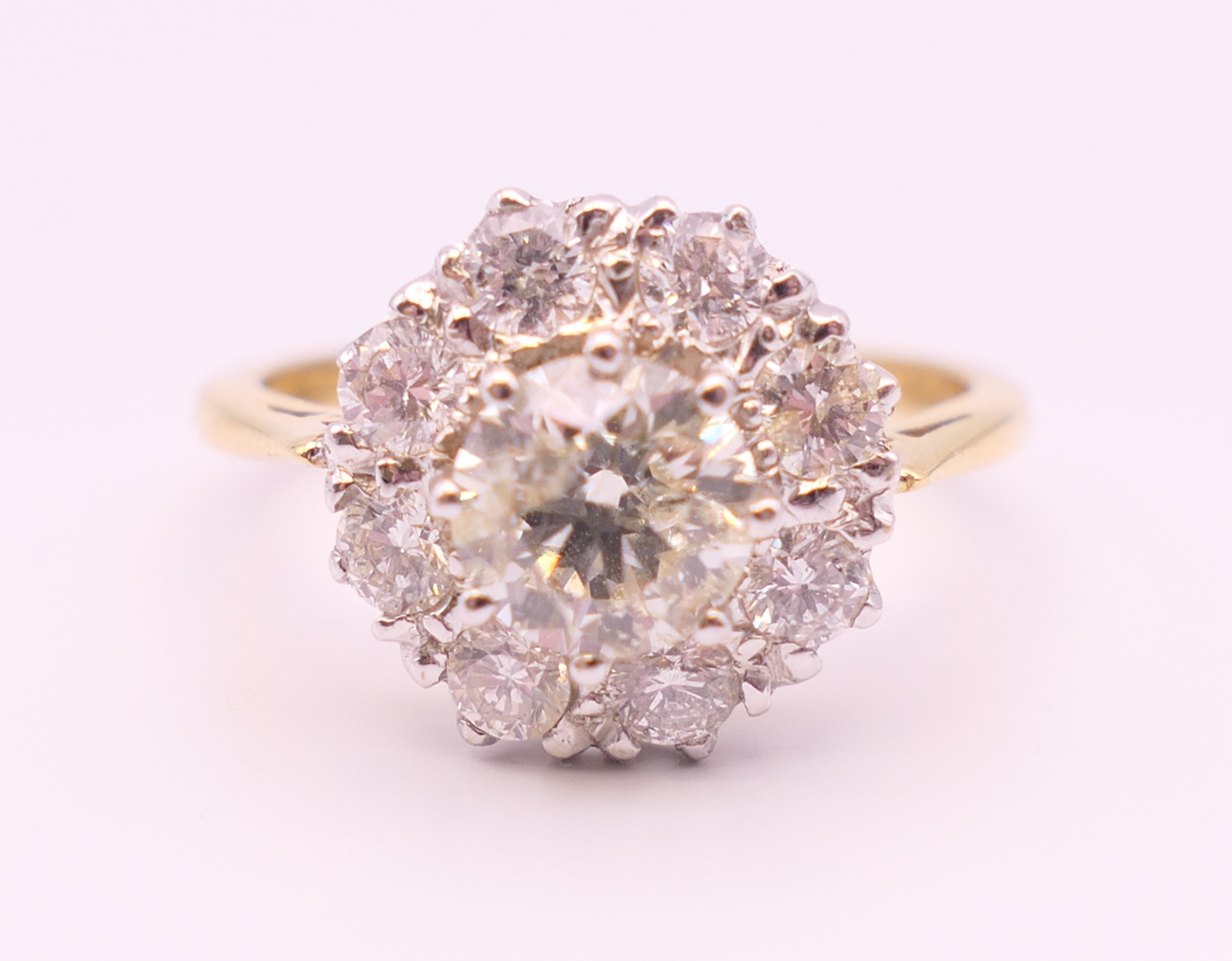 An 18 ct gold and diamond flowerhead ring. Total diamond weight approximately 1.85 carats. - Image 2 of 7