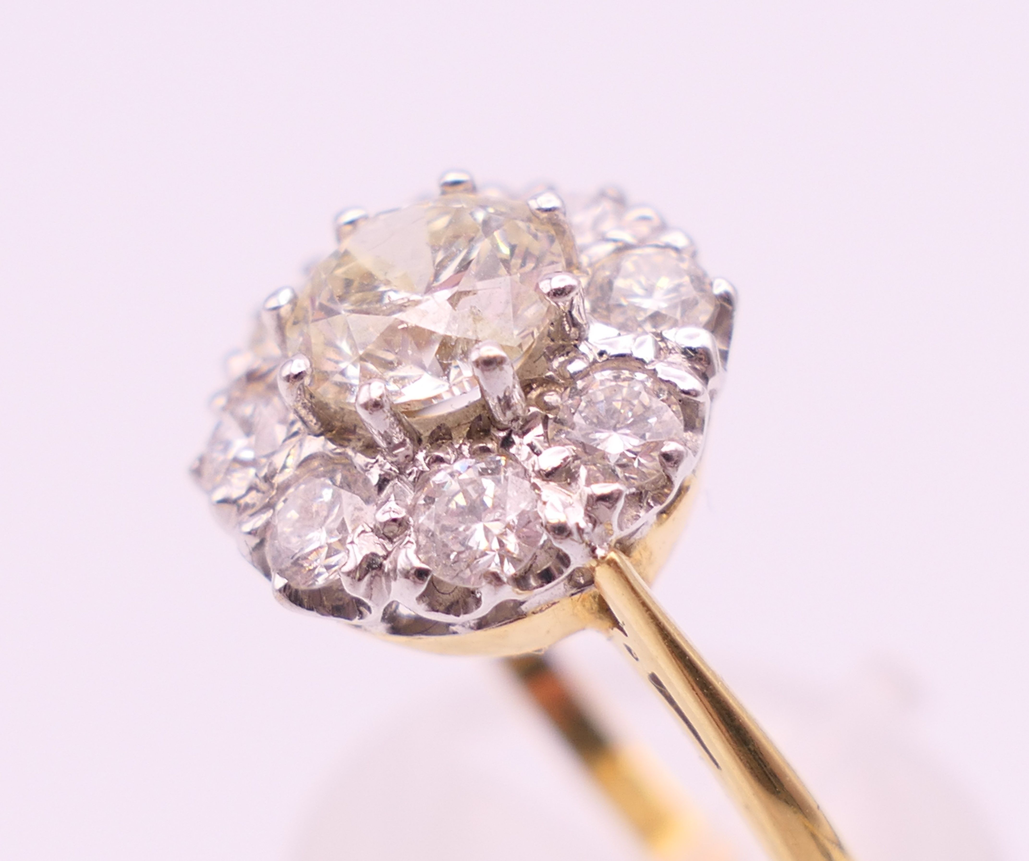 An 18 ct gold and diamond flowerhead ring. Total diamond weight approximately 1.85 carats. - Image 5 of 7