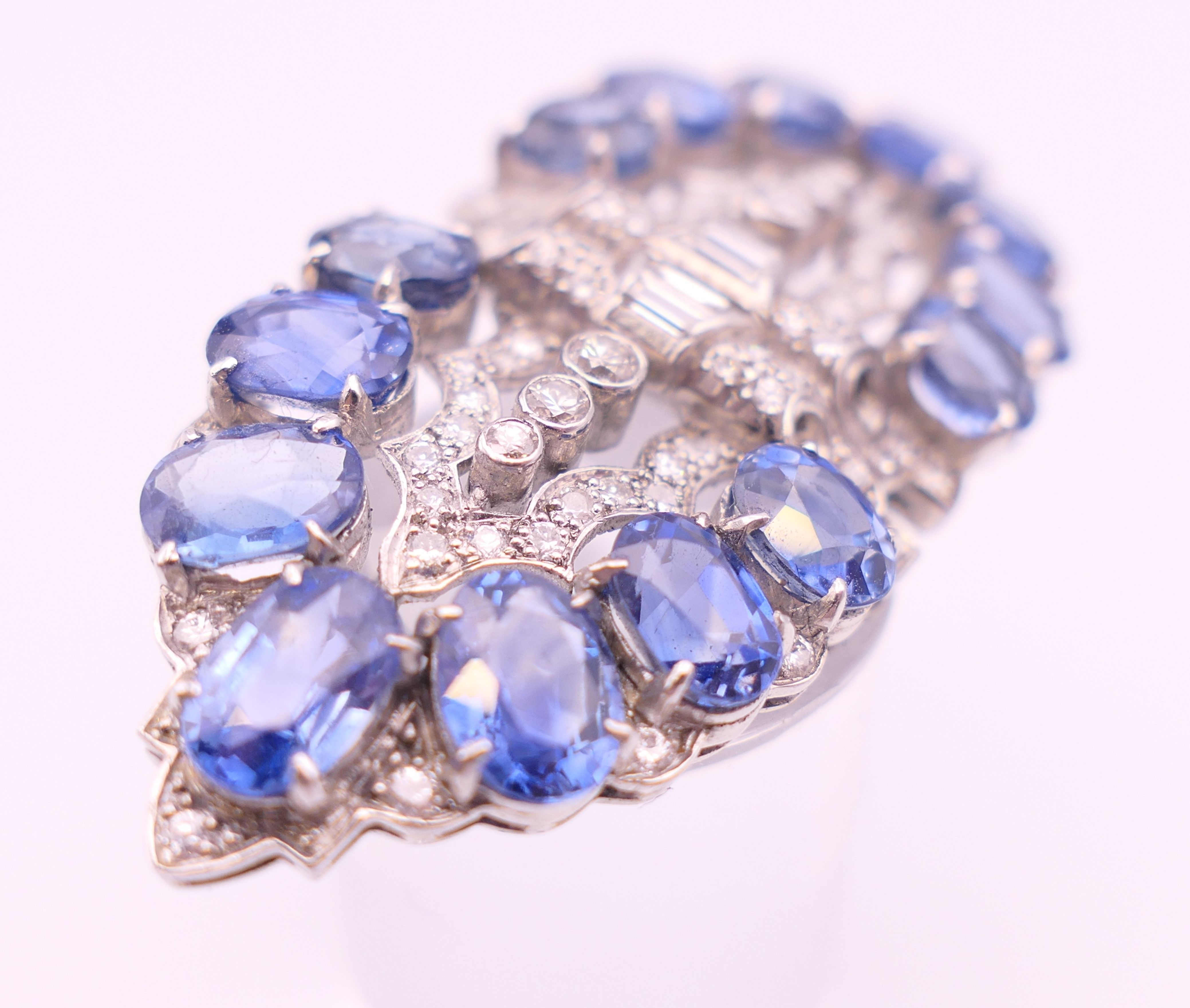 An unmarked Garrard and Co Ltd sapphire and diamond brooch, cased. 5 cm x 2 cm. - Image 14 of 19