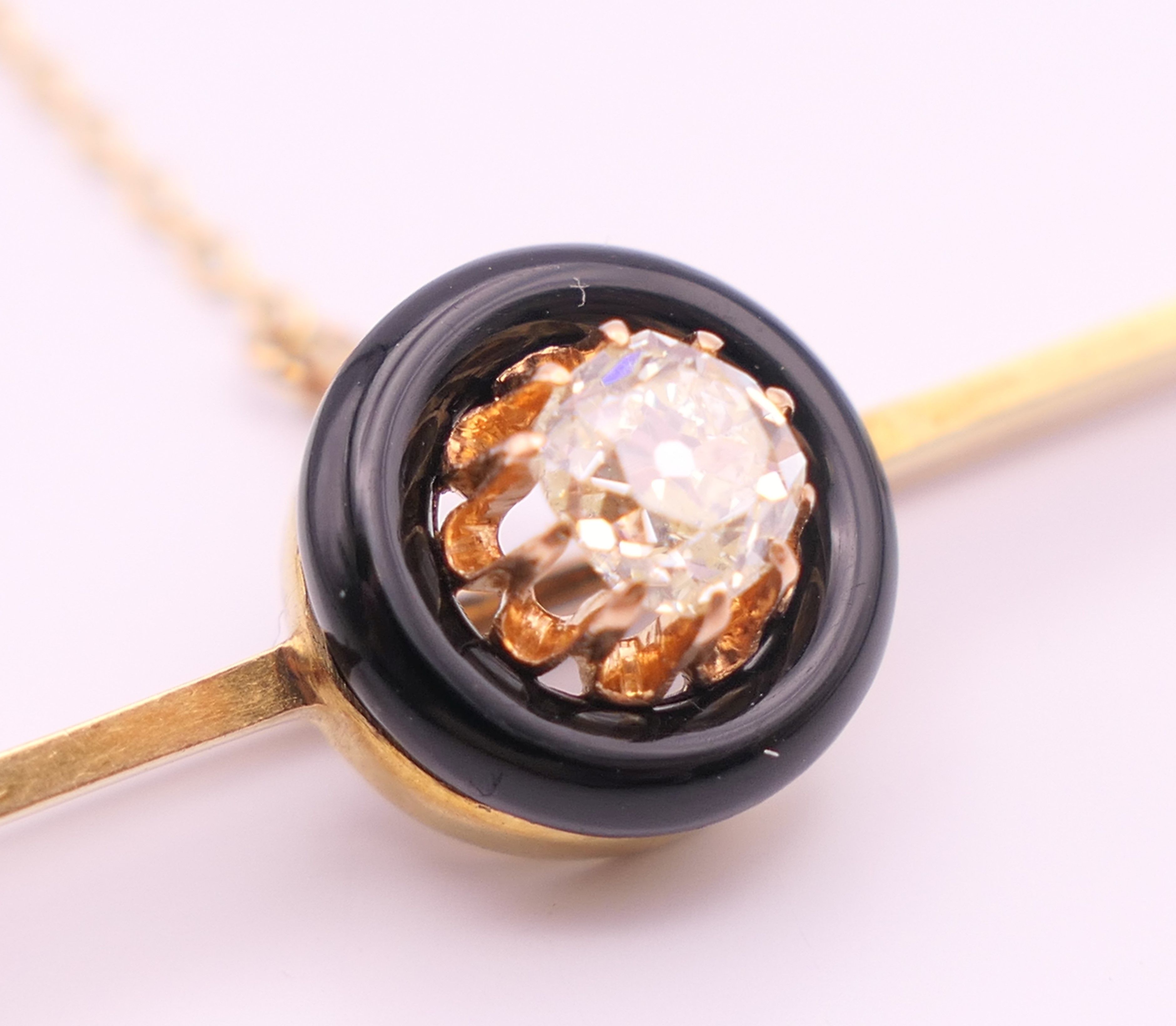 A 15 ct gold and 0.5 carat diamond set in a black circular mount mourning brooch/pin. 6 cm long. 4. - Image 4 of 5