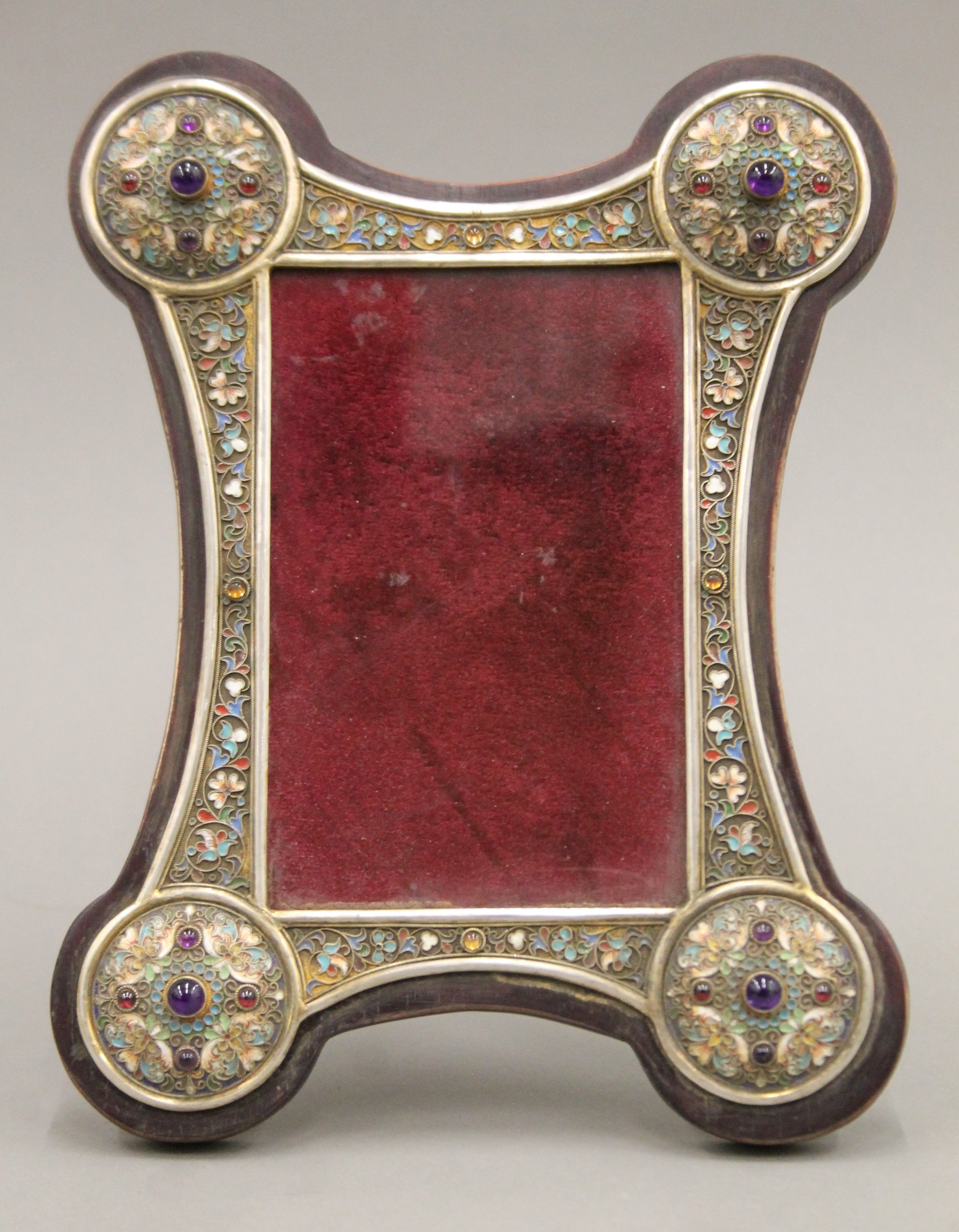 A cabochon set silver and enamel mounted photograph frame, bearing Russian marks. 24 cm high.