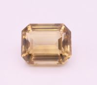 A large emerald cut citrine. 3 x 2.5 cm.