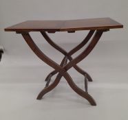 A folding coaching type table. 46 cm wide.