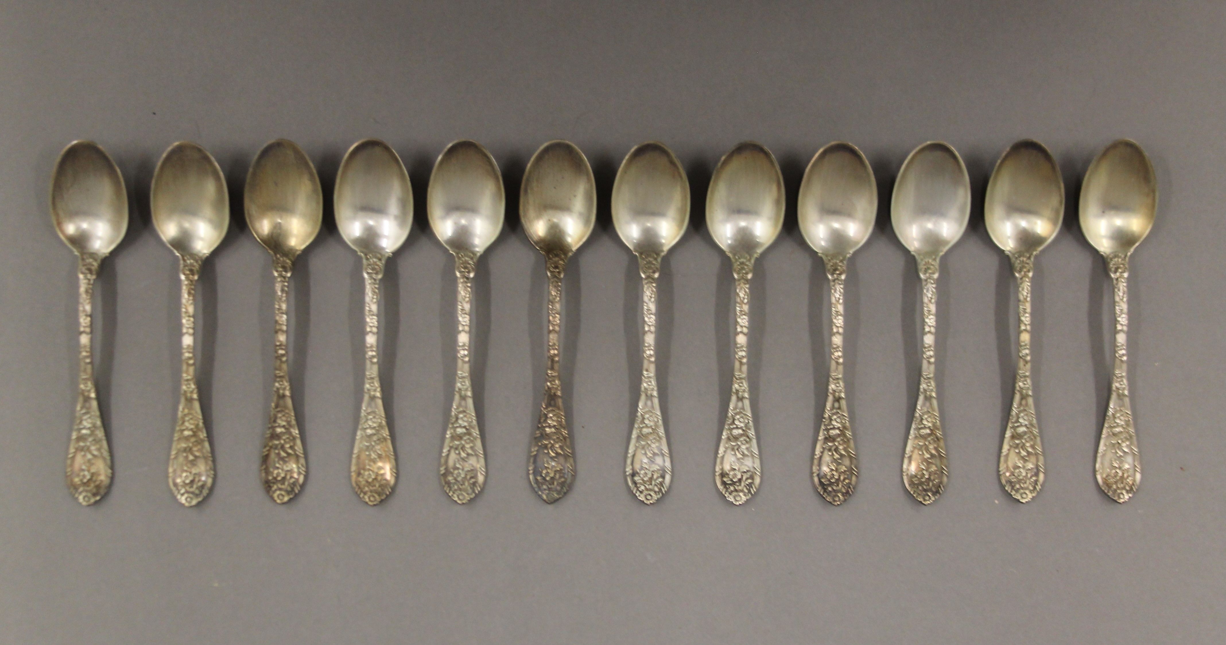 A cased set of twelve silver teaspoons, in Maple & Co box. 165.5 grammes.