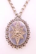 A silver locket on a long silver chain. Locket 5 cm high. 56.1 grammes.