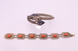 A Chinese enamel decorated dragon bracelet and a coral bracelet. Coral bracelet 19.5 cm long.