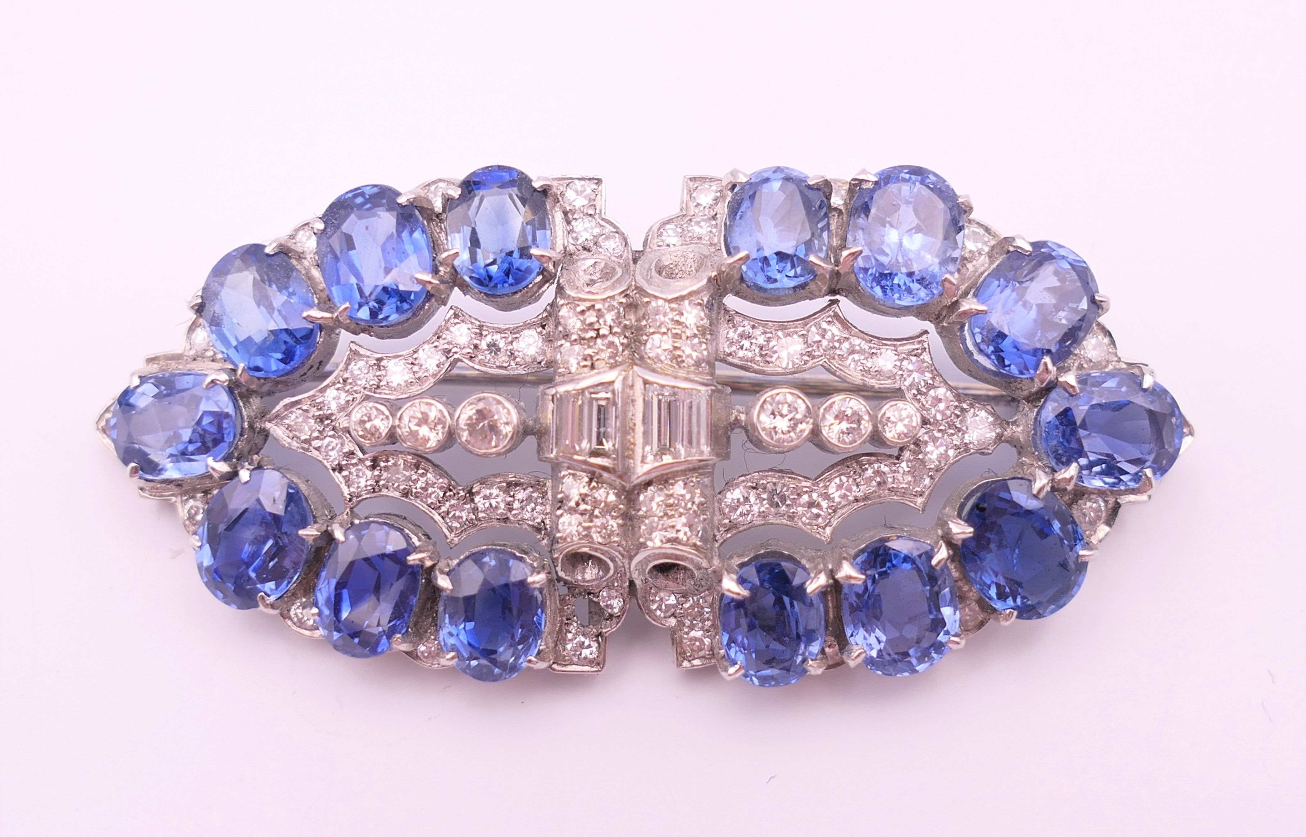 An unmarked Garrard and Co Ltd sapphire and diamond brooch, cased. 5 cm x 2 cm.