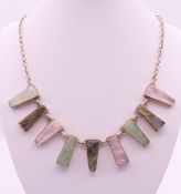 A silver necklace set with various stones. 45 cm long.