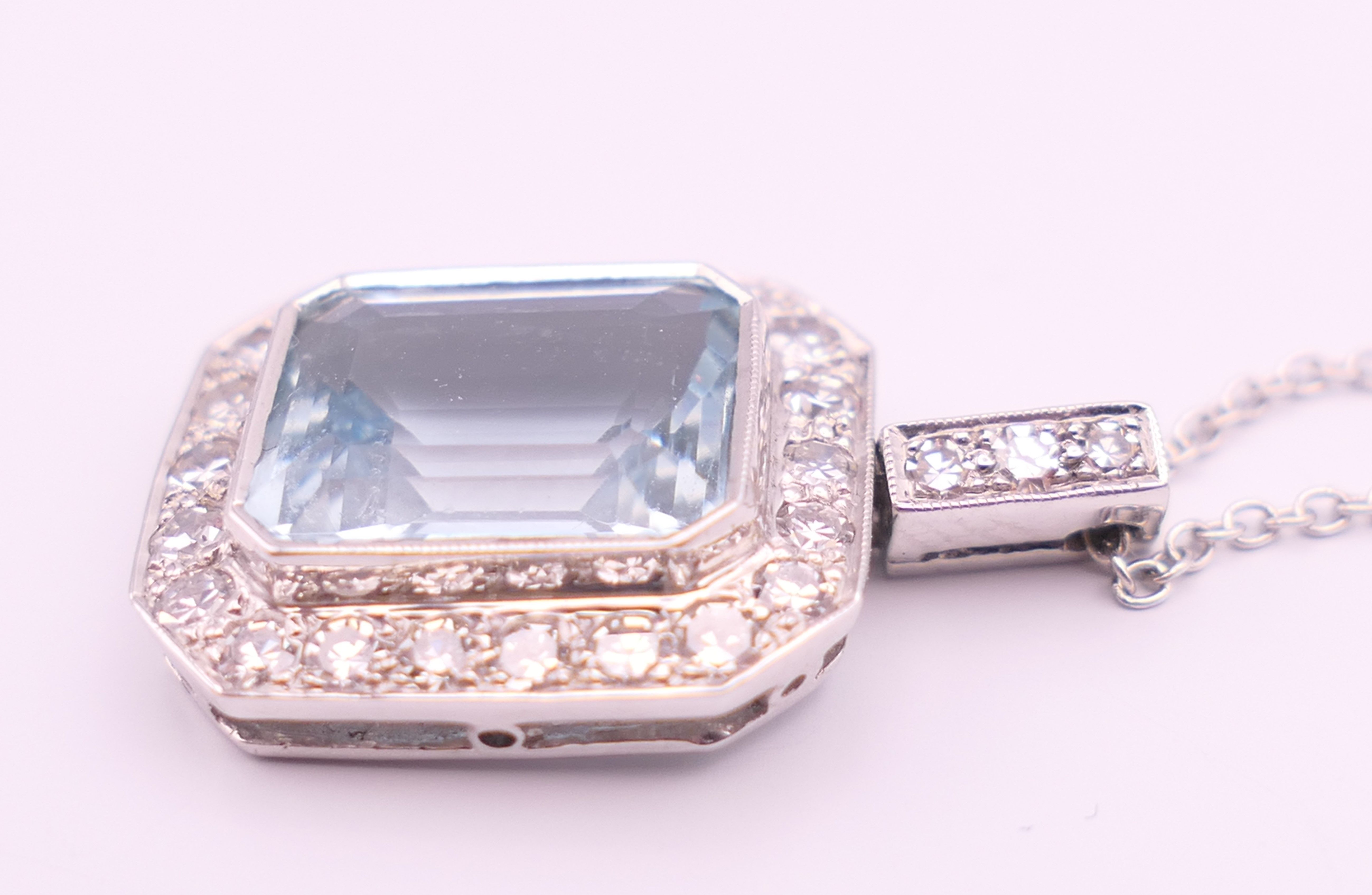 An 18 ct white gold emerald cut aquamarine and diamonds pendant on chain. - Image 3 of 6