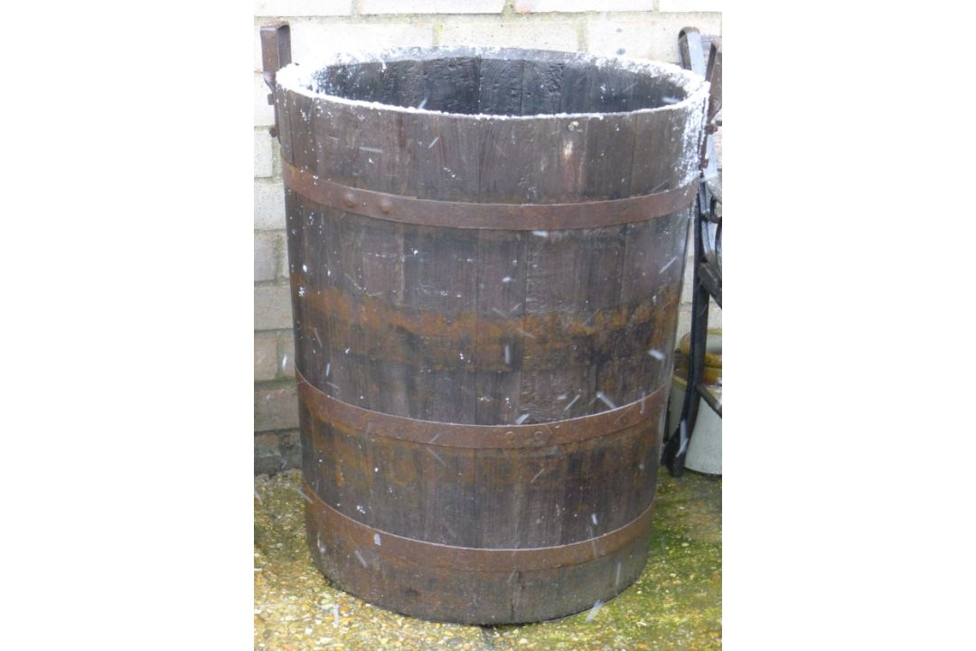 A coppered barrel form garden planter.