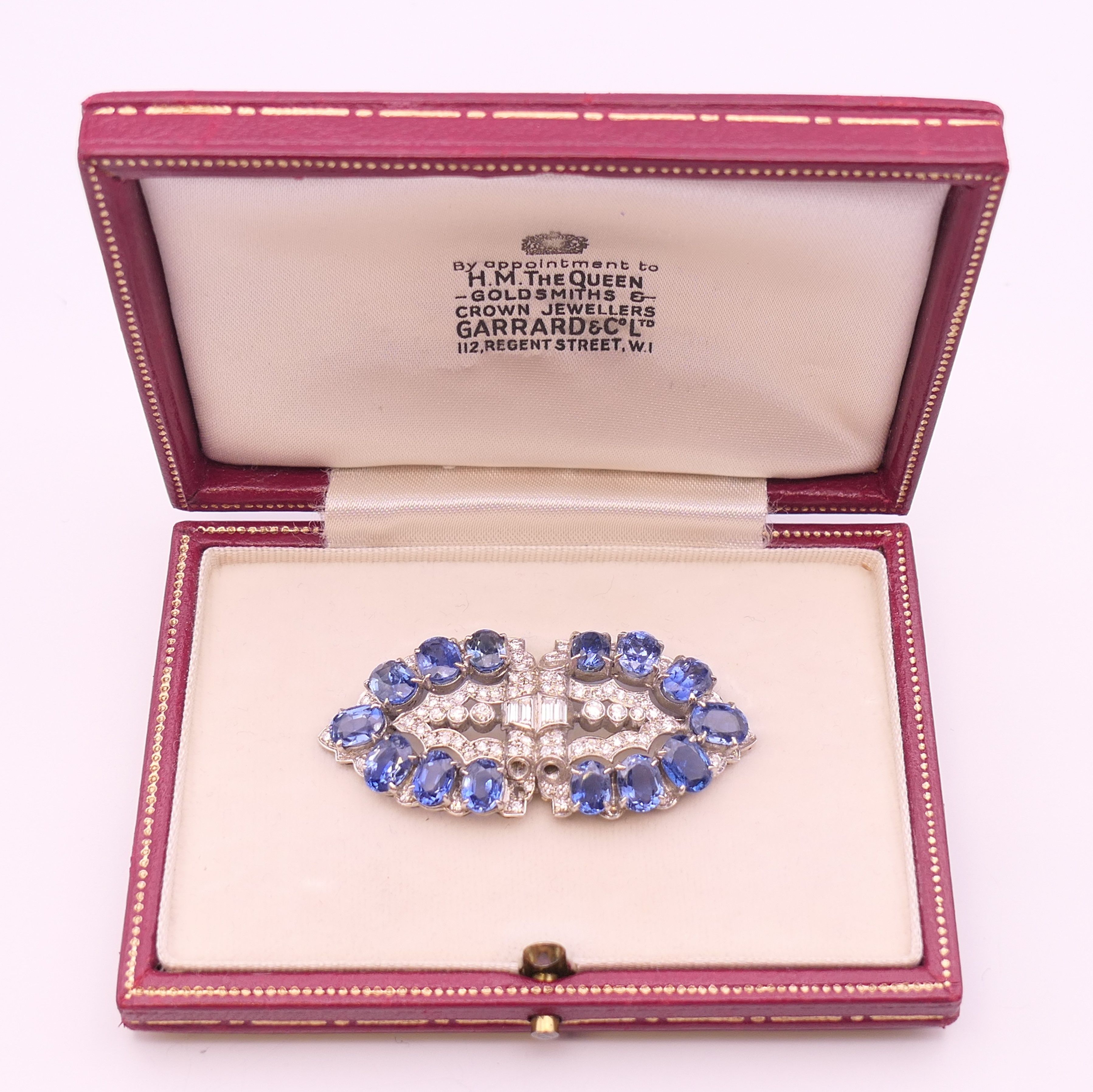 An unmarked Garrard and Co Ltd sapphire and diamond brooch, cased. 5 cm x 2 cm. - Image 15 of 19