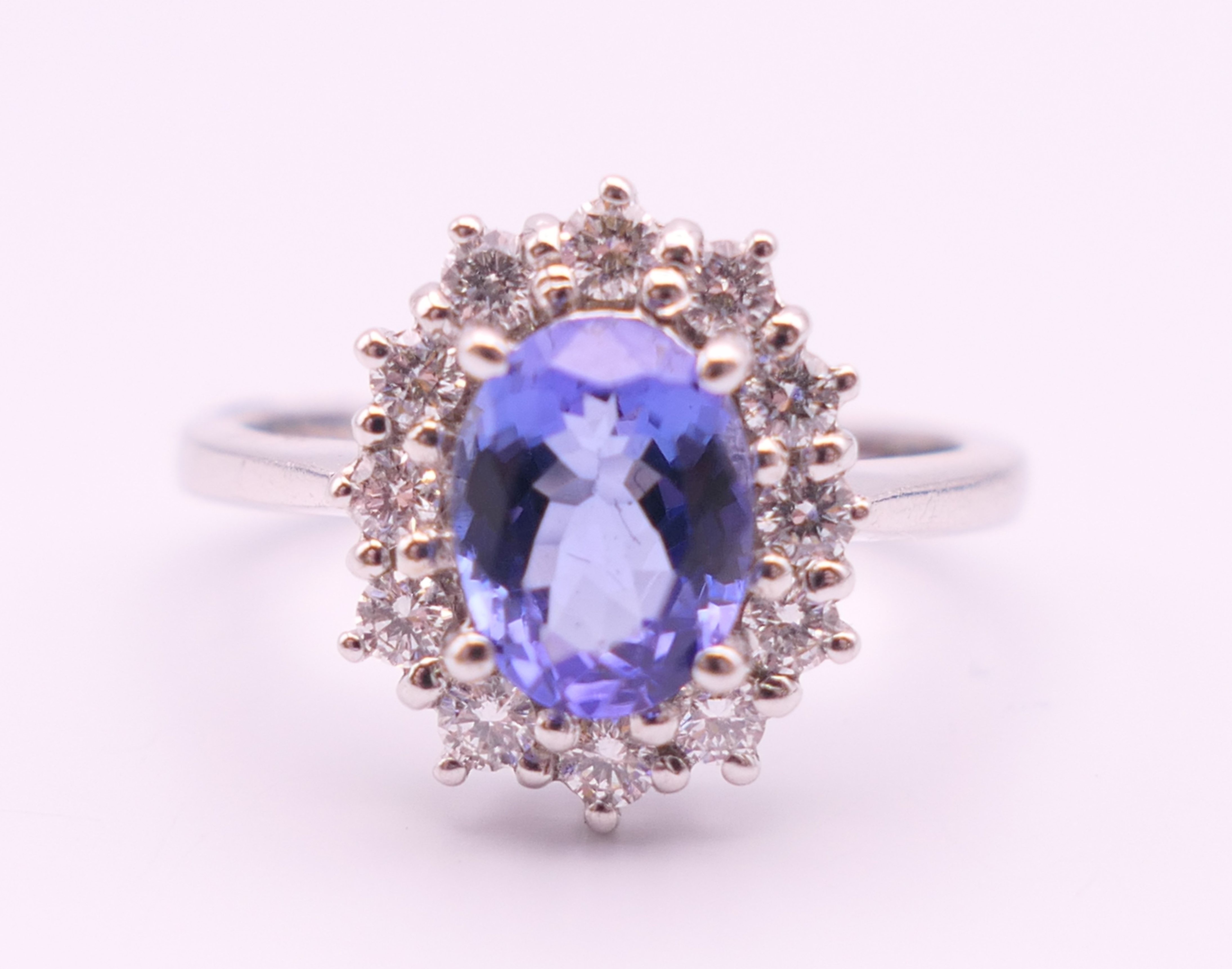 An 18 ct white gold sapphire and diamond ring. The sapphire approximately 1 carat. Ring size N.