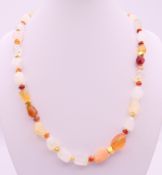 A rough cut opal and gold mounted necklace. 48 cm long.