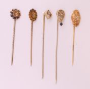 Five various diamond set stickpins. Largest 6.5 cm long.