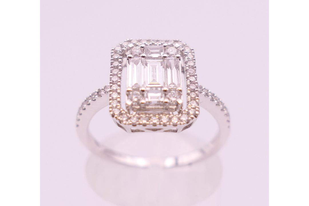 An 18 ct white gold ring with 5 baguette cut diamonds surrounded by numerous brilliant cut diamonds. - Image 3 of 8