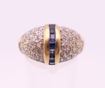 An 18 ct gold sapphire ring. Ring size P/Q. 5.6 grammes total weight.