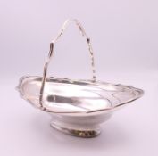 A silver basket. 18 cm long. 171.3 grammes.