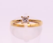 An 18 ct gold solitaire diamond ring. Ring size I. 2.6 grammes total weight.