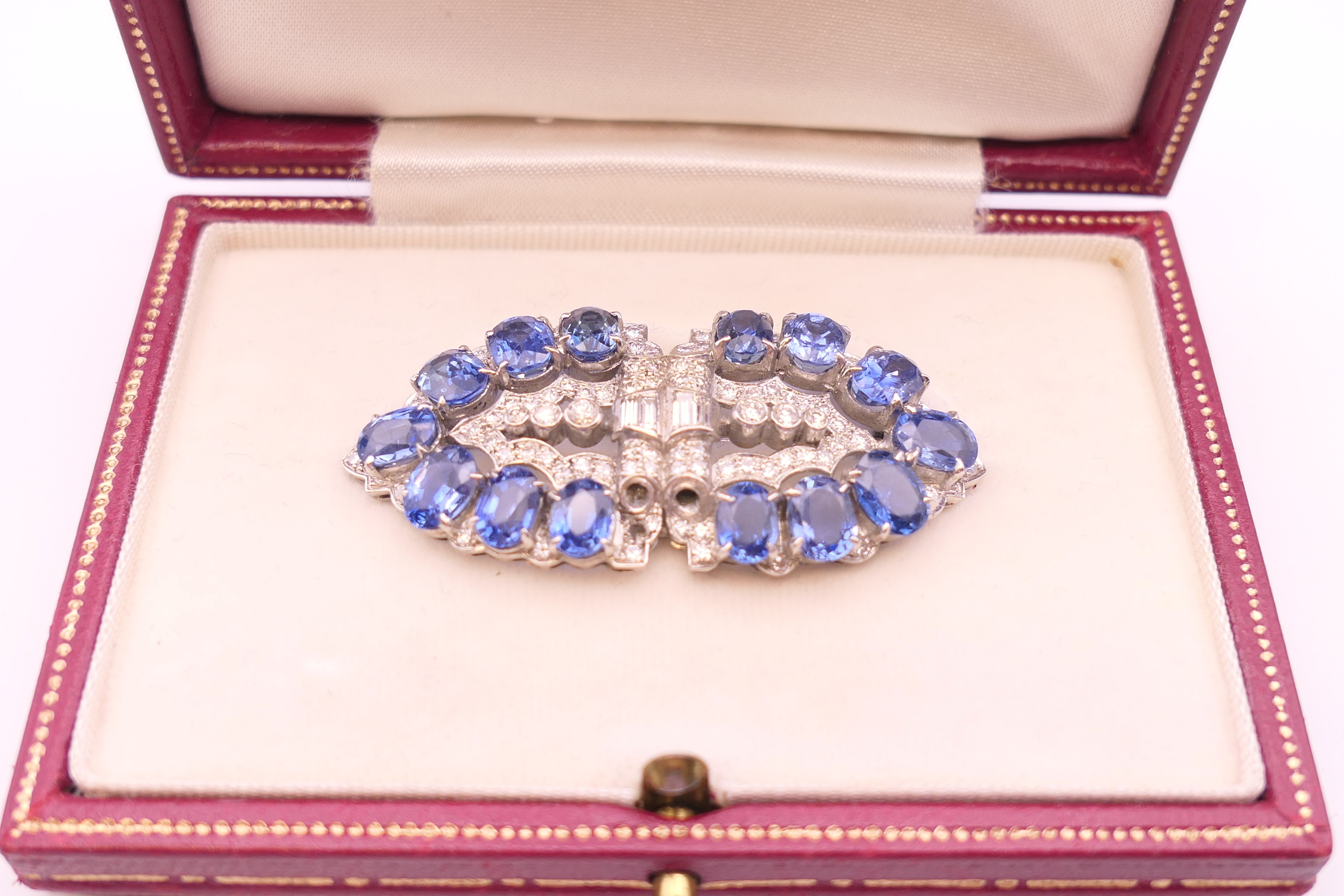 An unmarked Garrard and Co Ltd sapphire and diamond brooch, cased. 5 cm x 2 cm. - Image 18 of 19