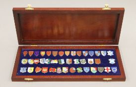A boxed set of enamelled silver heraldic shield badges (one lacking).