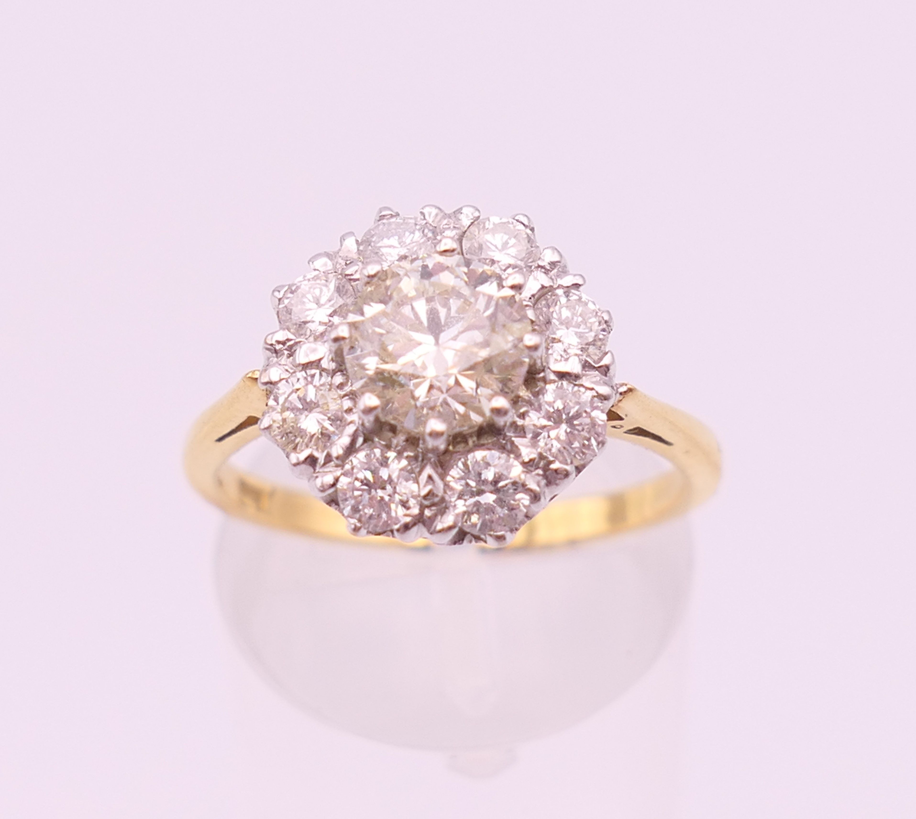 An 18 ct gold and diamond flowerhead ring. Total diamond weight approximately 1.85 carats.