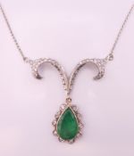 An 18 ct gold, diamond and emerald pendant necklace. Emerald pendant drop 2.