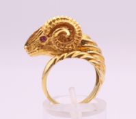 An 18 ct gold ruby and diamond ram's head form ring. Ring size K. 12.8 grammes total weight.