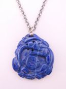 A carved lapis dragon pendant on chain. Pendant 4 cm high, chain 66 cm long.