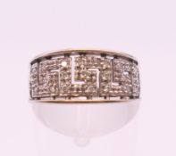 A 9 ct white gold Greek key design diamond set ring. Ring size L. 2.8 grammes total weight.