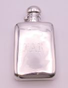 A silver spirit flask of typical form, Birmingham 1928. 14 cm long. 146.9 grammes.