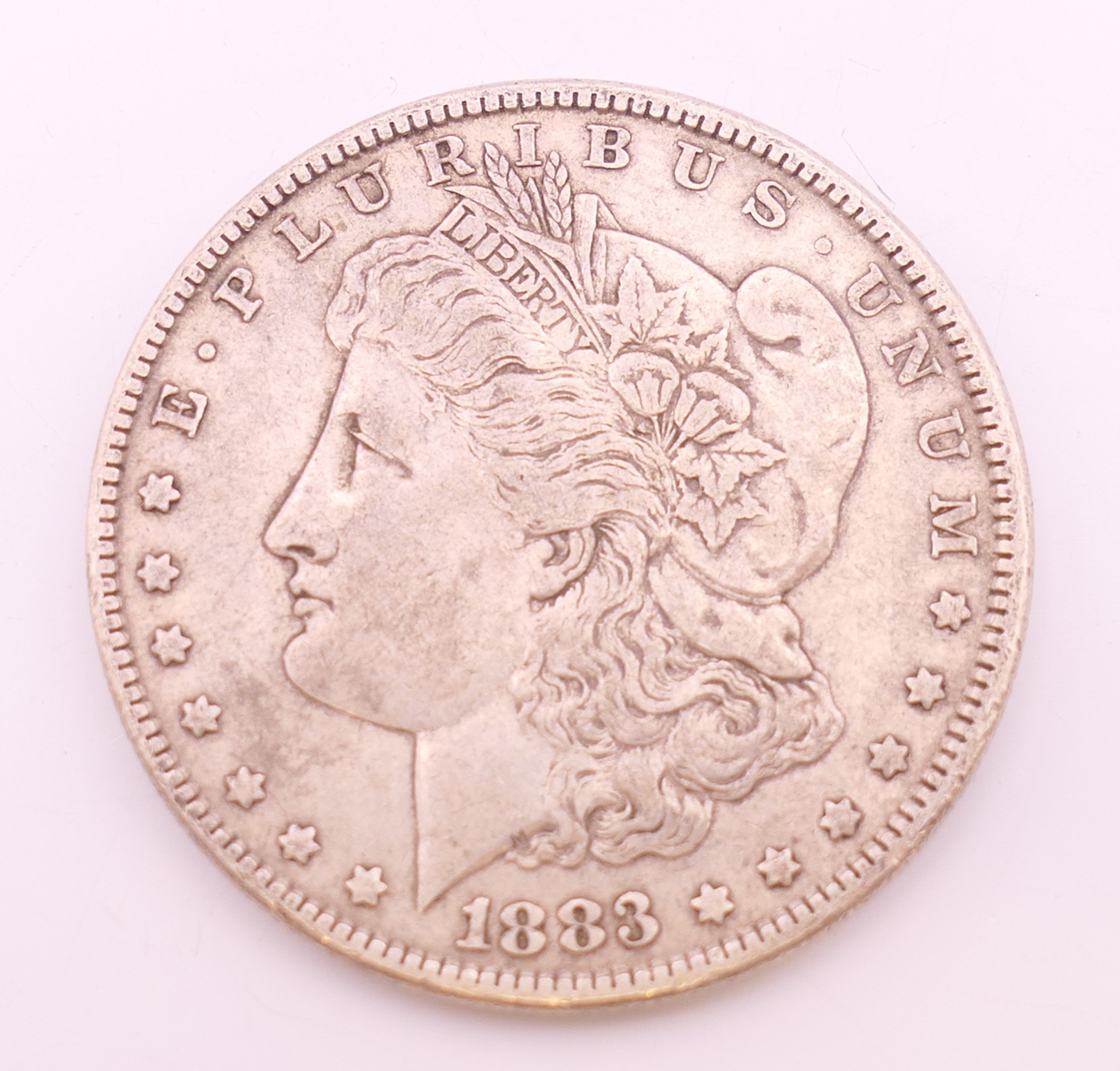An 1883 Morgan silver dollar coin.