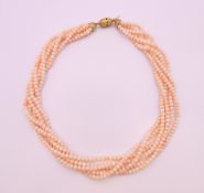 A six strand pearl necklace with an 18 ct gold clasp. 50 cm long.