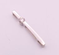 A 9 ct white gold diamond set pendant. 2.5 cm long. 0.9 grammes total weight.