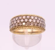 An 18 ct yellow and white gold diamond set ring. Approximately 1 carat total diamond weight.