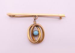 A 15 ct gold pin with plated turquoise set pendant. 5 cm long, pendant 2 cm high. 5.