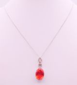 A silver pendant and chain. Pendant 3 cm high, chain 46 cm long.