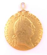 A 1787 gold spade guinea with suspension loop. 2.5 cm diameter. 8.5 grammes total weight.